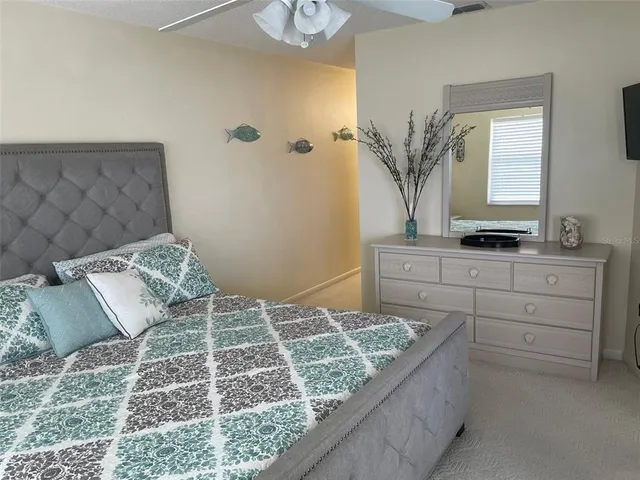 a bedroom with a large bed and a dresser