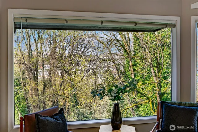 a living room with furniture a dining table and a chandelier