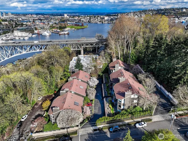 a view of a house with a yard and potted plants