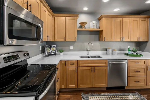 a kitchen with a sink stove and microwave