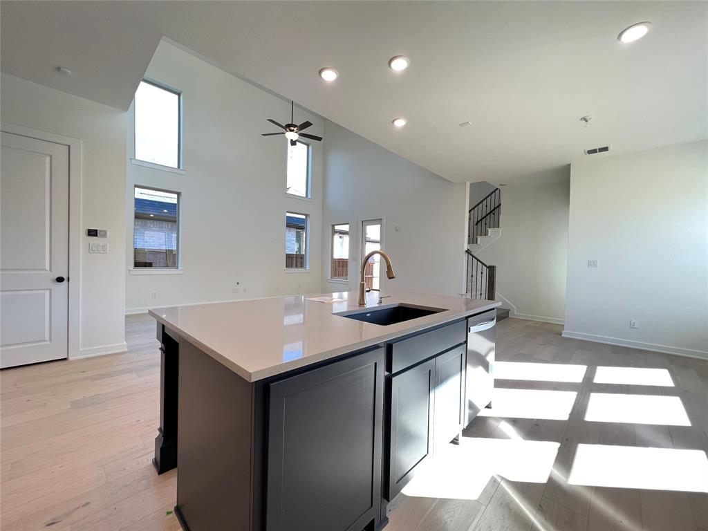 15625 Hawks Pass Road Frisco, TX 75035 - Photo 11 of 27 a kitchen with a sink and a refrigerator