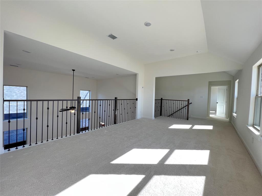 15625 Hawks Pass Road Frisco, TX 75035 - Photo 14 of 27 a bedroom with a bed and painting on the wall