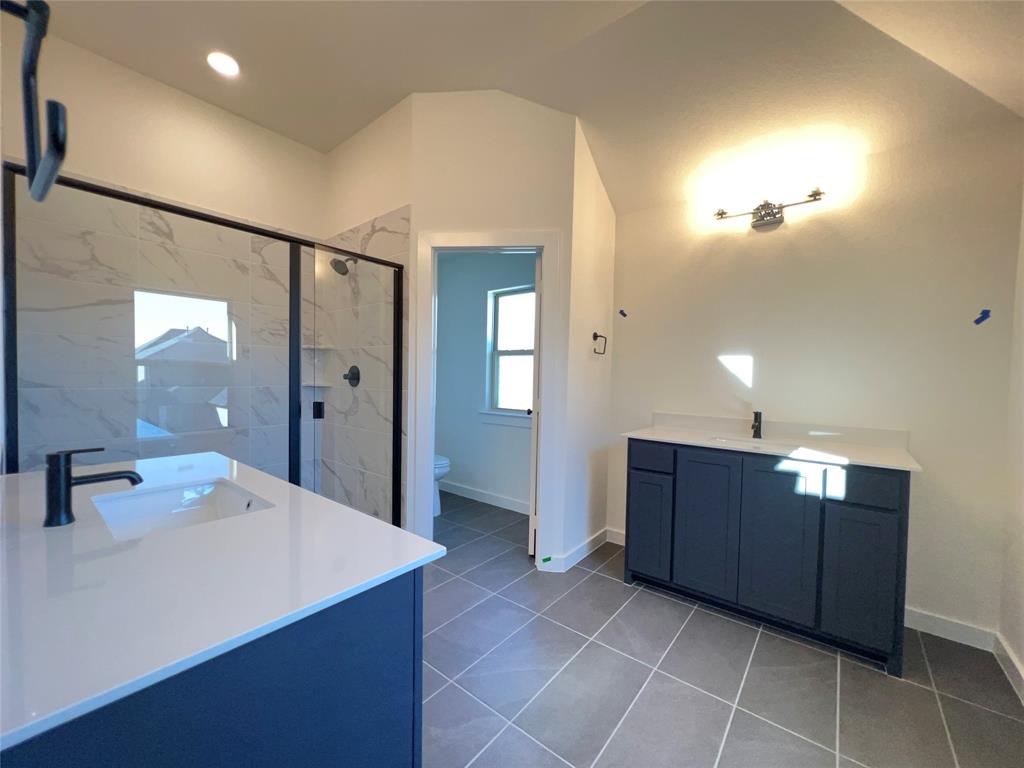 15625 Hawks Pass Road Frisco, TX 75035 - Photo 19 of 27 a large bathroom with a sink and a mirror