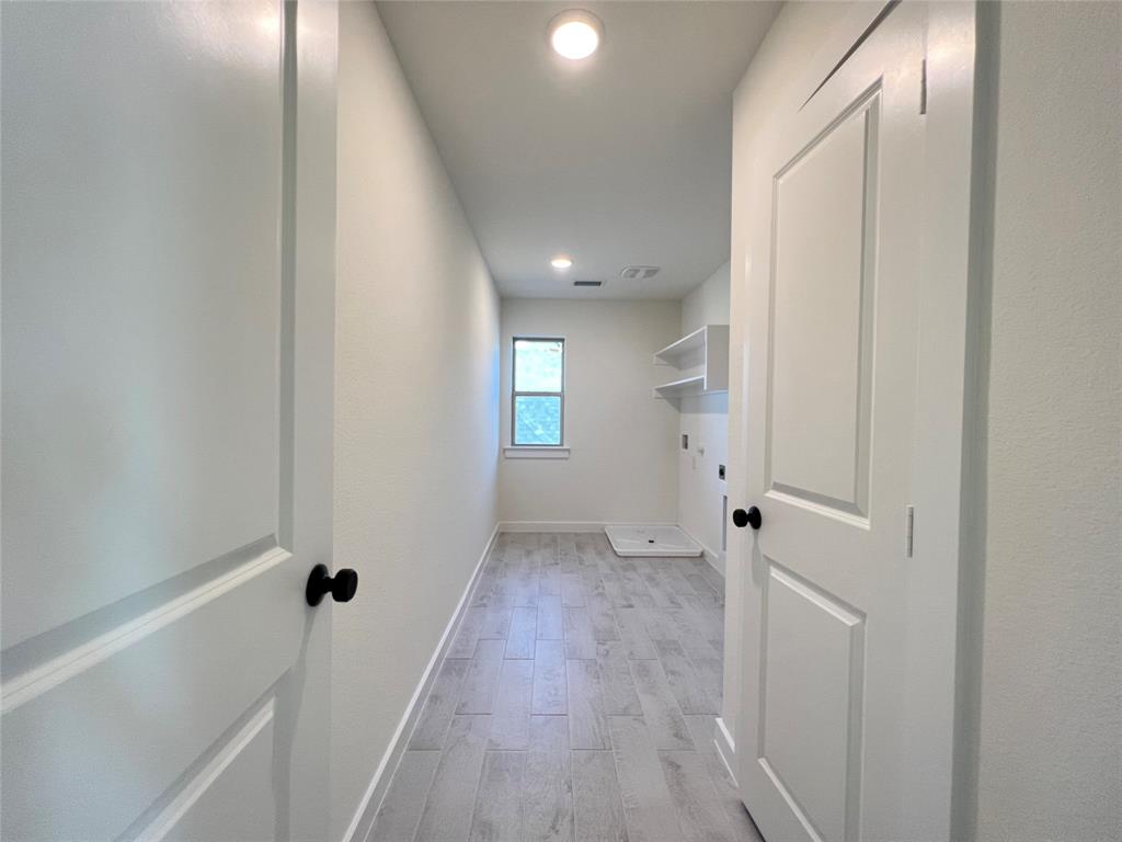 15625 Hawks Pass Road Frisco, TX 75035 - Photo 24 of 27 a view of an empty room with wooden floor and a window