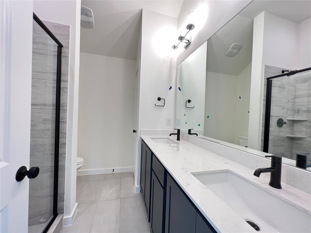 15625 Hawks Pass Road Frisco, TX 75035 - Photo 25 of 27 a bathroom with a sink and mirror