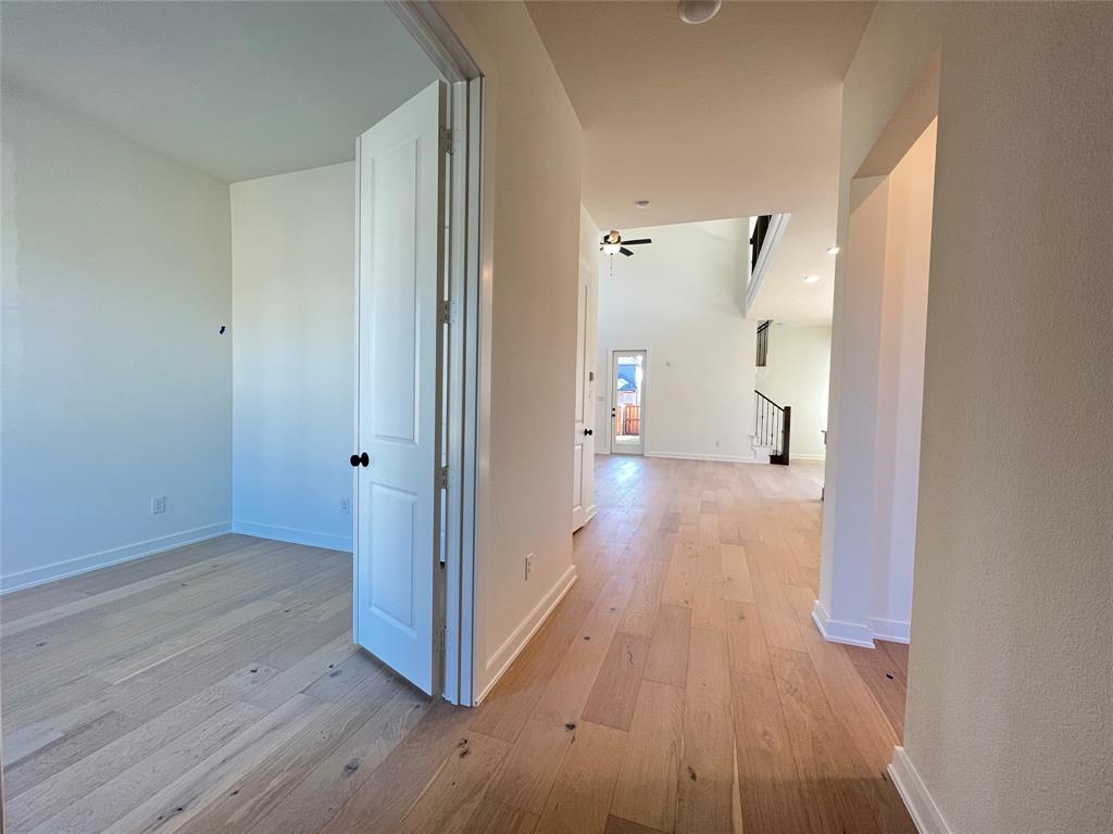 15625 Hawks Pass Road Frisco, TX 75035 - Photo 5 of 27 a view of a hallway with wooden floor