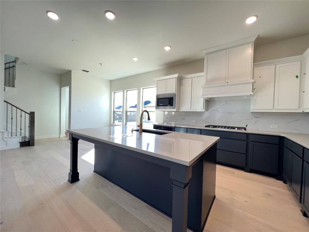 15625 Hawks Pass Road Frisco, TX 75035 - Photo 9 of 27 a kitchen with stainless steel appliances granite countertop a sink stove and refrigerator