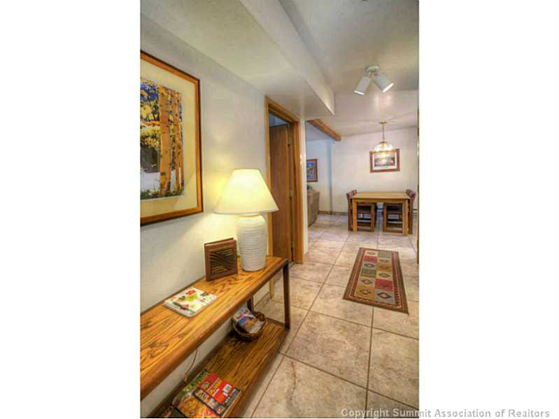 875 4 O Clock Road, Unit 2 Breckenridge, CO 80424 - Photo 2 of 13 a living room with a couch and a table