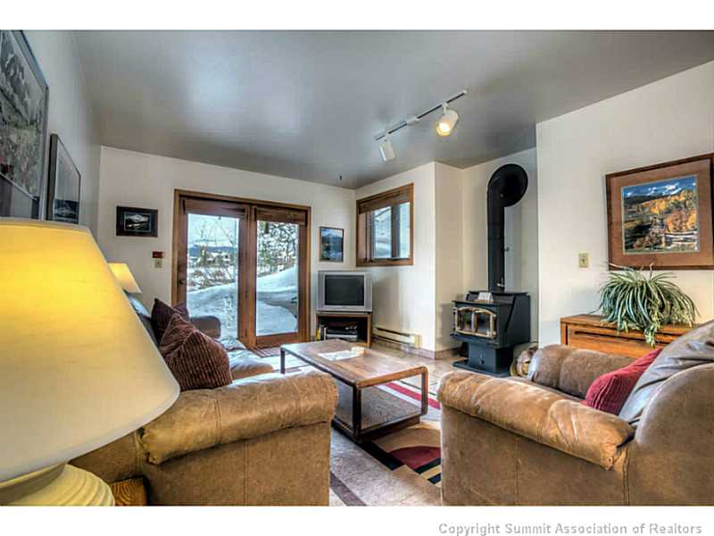 875 4 O Clock Road, Unit 2 Breckenridge, CO 80424 - Photo 3 of 13 a living room with furniture and a flat screen tv