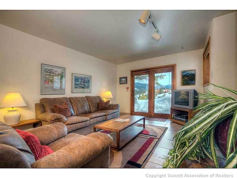 875 4 O Clock Road, Unit 2 Breckenridge, CO 80424 - Photo 6 of 13 a living room with furniture a flat screen tv and a window