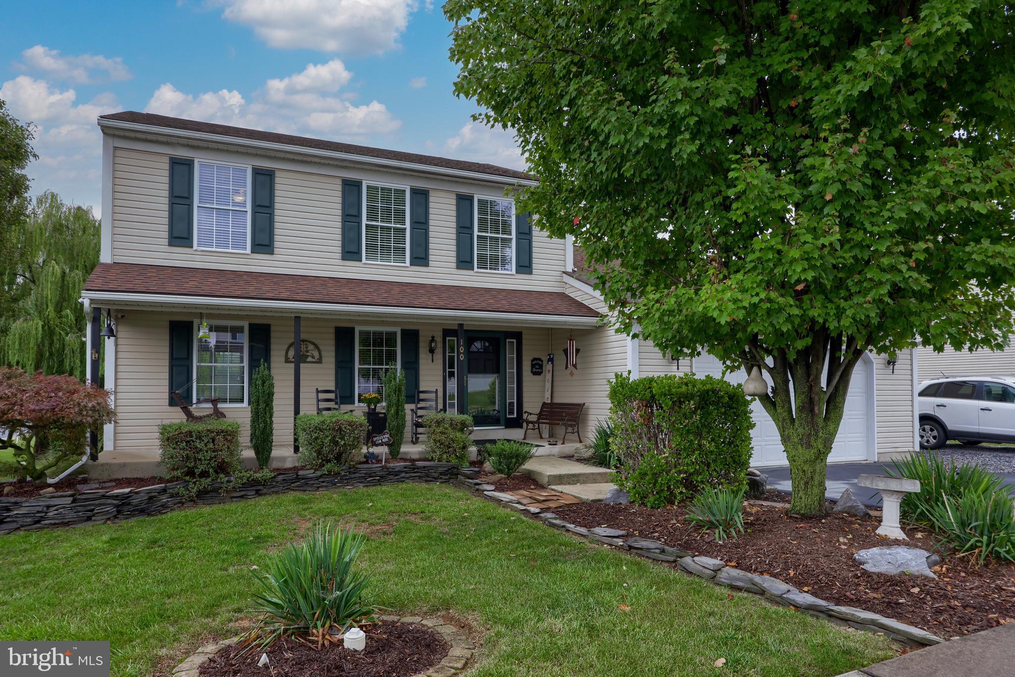 100 Roxberry Drive Reading, PA 19608 - Photo 1 of 46 a front view of a house with garden and trees