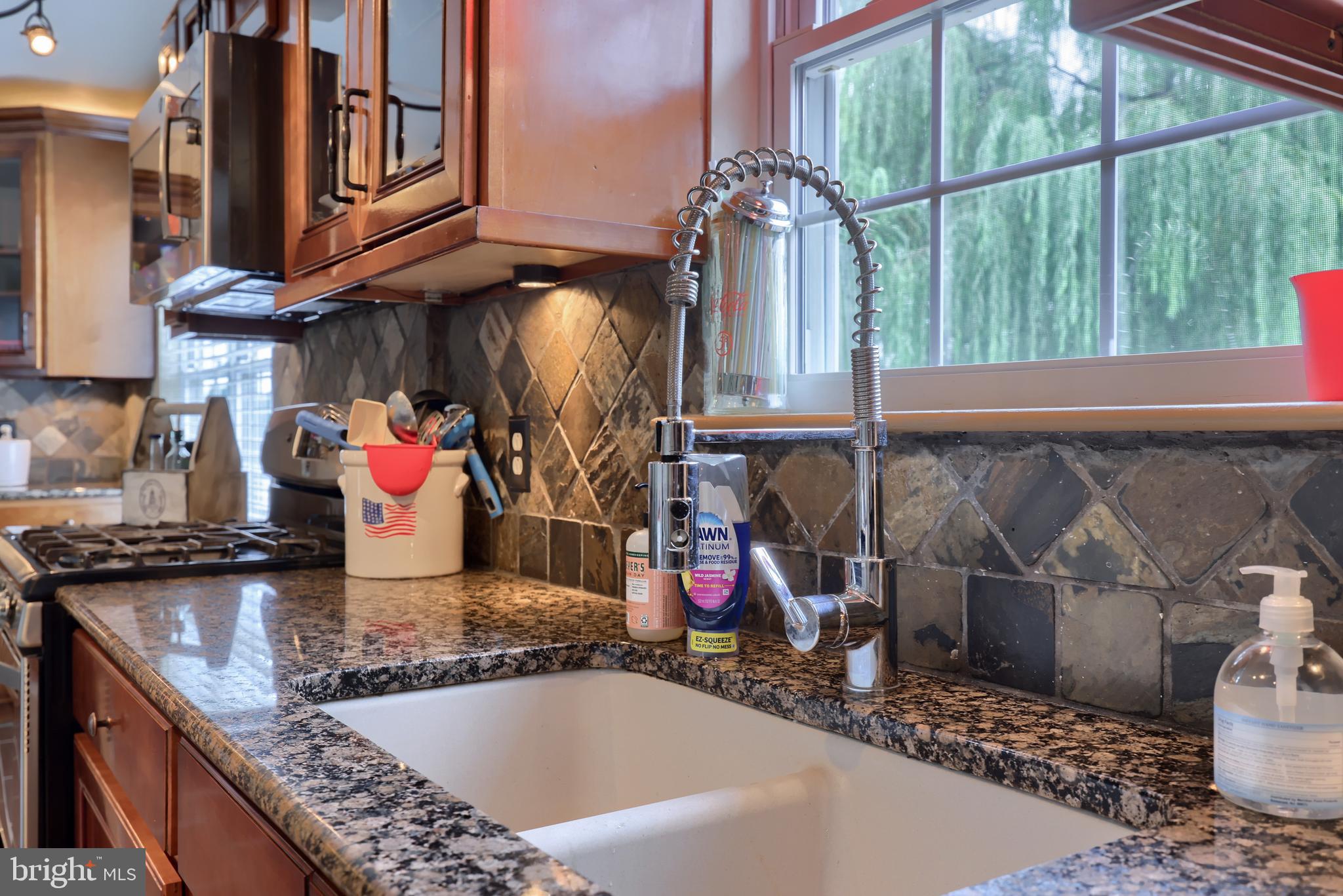 100 Roxberry Drive Reading, PA 19608 - Photo 18 of 46 a kitchen filled with a granite countertop sink and a stove