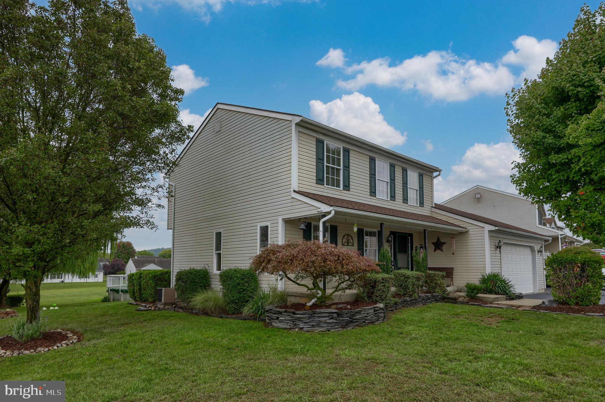 100 Roxberry Drive Reading, PA 19608 - Photo 2 of 46 a front view of a house with a garden and trees