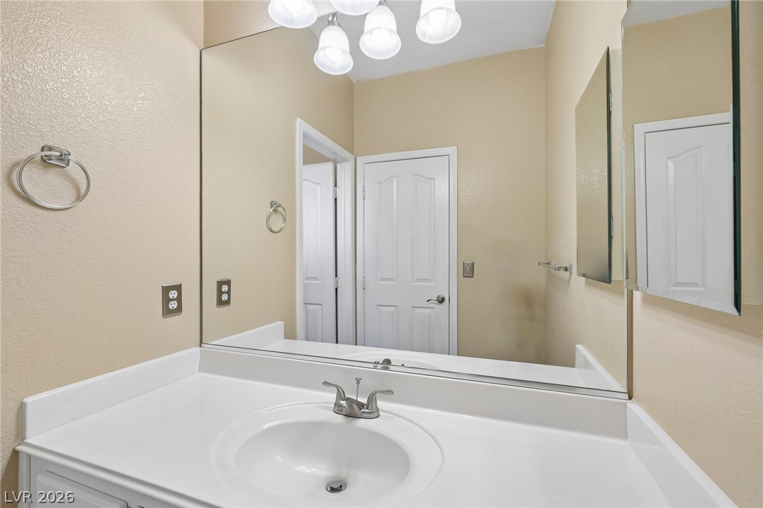 1727 Millstream Way Henderson, NV 89074 - Photo 36 of 46 A pristine vanity with ample counter space and a large mirror defines this functional bathroom.