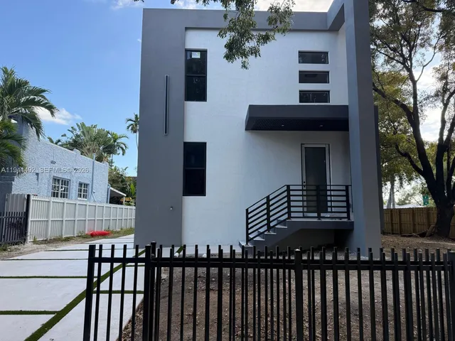 a view of a house with wooden fence