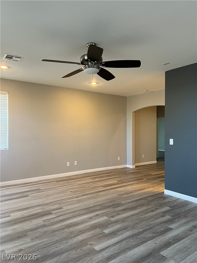5981 Honeysuckle Ridge Street Las Vegas, NV 89148 - Photo 16 of 29 A versatile living area features sleek wood-look flooring and a contemporary ceiling fan.