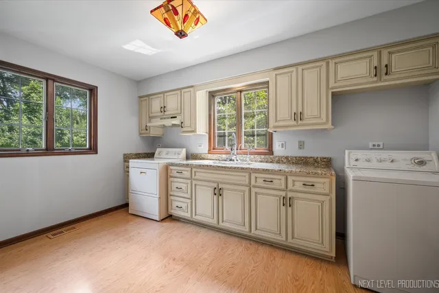 a kitchen that has a sink and a stove in it
