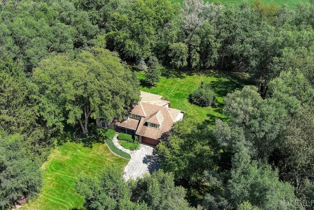 an aerial view of a house with a yard