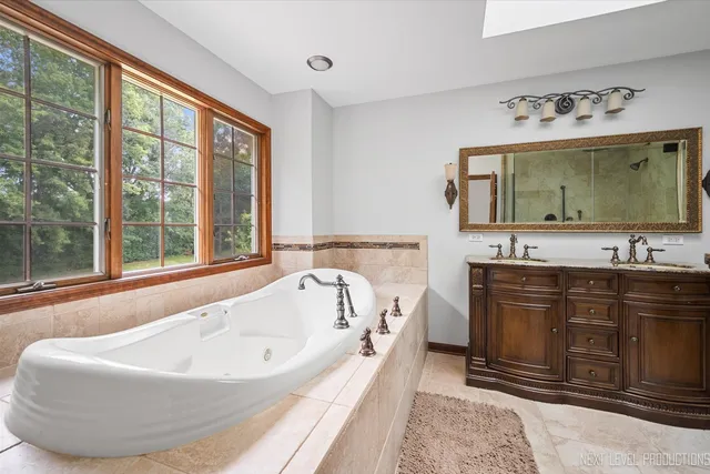a bathroom with a granite countertop sink a toilet and shower