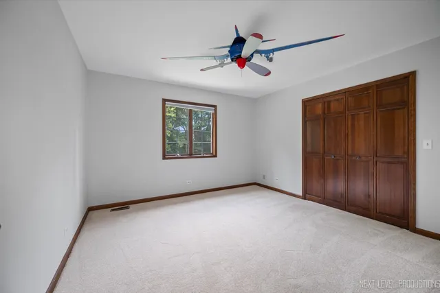a spacious bathroom with a granite countertop sink and a mirror
