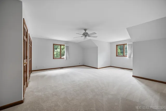 an empty room with windows and closet