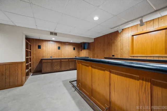 an aerial view of residential house with outdoor space and trees all around