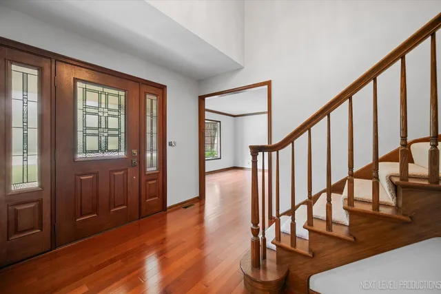 a view of an entryway with wooden floor and door