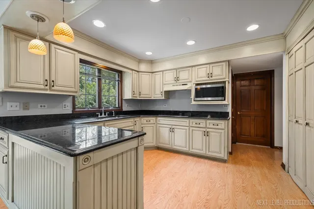 a kitchen with stainless steel appliances granite countertop a sink stove and cabinets