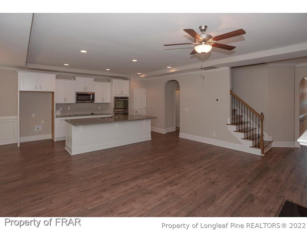 475 Kerr Lake Road Aberdeen, NC 28315 - Photo 14 of 29 a view of an empty room with wooden floor and a ceiling fan