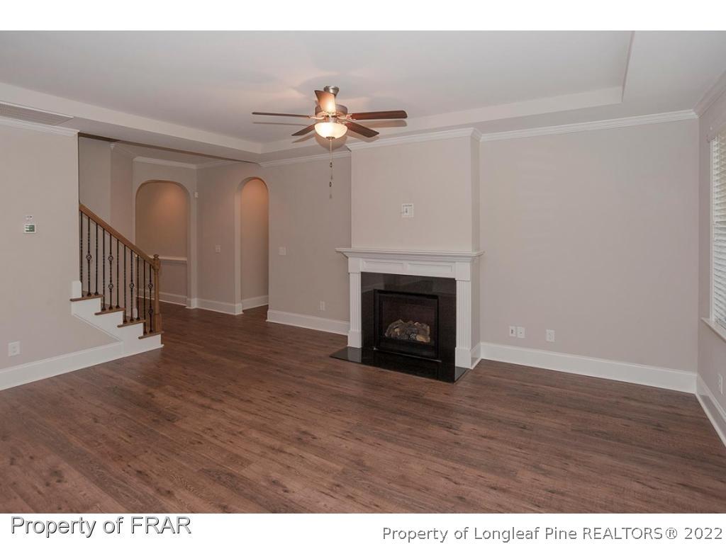 475 Kerr Lake Road Aberdeen, NC 28315 - Photo 15 of 29 a view of an empty room with wooden floor a fireplace and a window