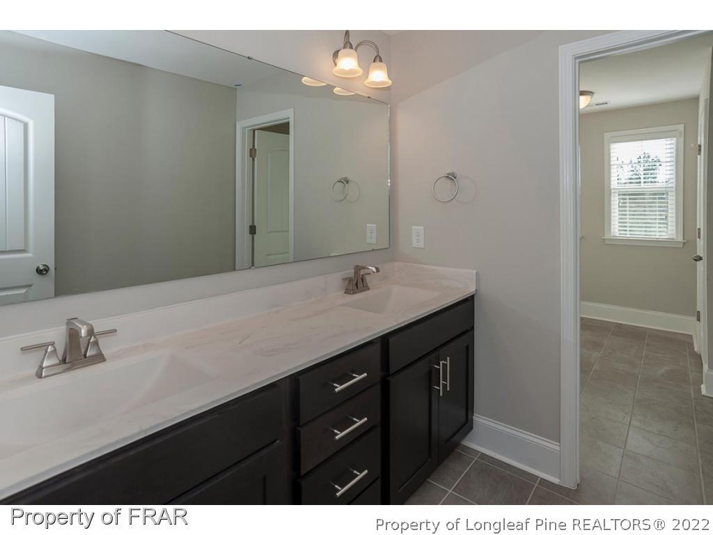 475 Kerr Lake Road Aberdeen, NC 28315 - Photo 26 of 29 a bathroom with a sink double vanity and a mirror