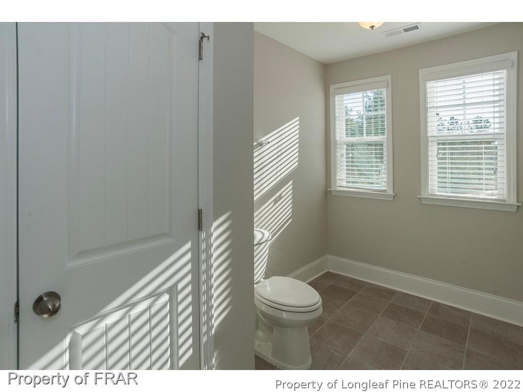 475 Kerr Lake Road Aberdeen, NC 28315 - Photo 28 of 29 a bathroom with a toilet a sink and a shower