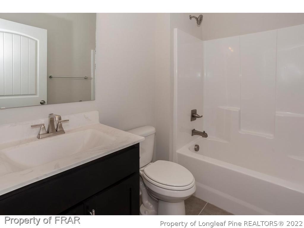 475 Kerr Lake Road Aberdeen, NC 28315 - Photo 6 of 29 a bathroom with a sink a toilet and shower