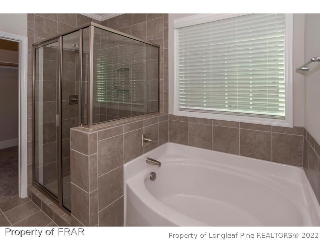 475 Kerr Lake Road Aberdeen, NC 28315 - Photo 10 of 29 a bathroom with a bathtub and a shower