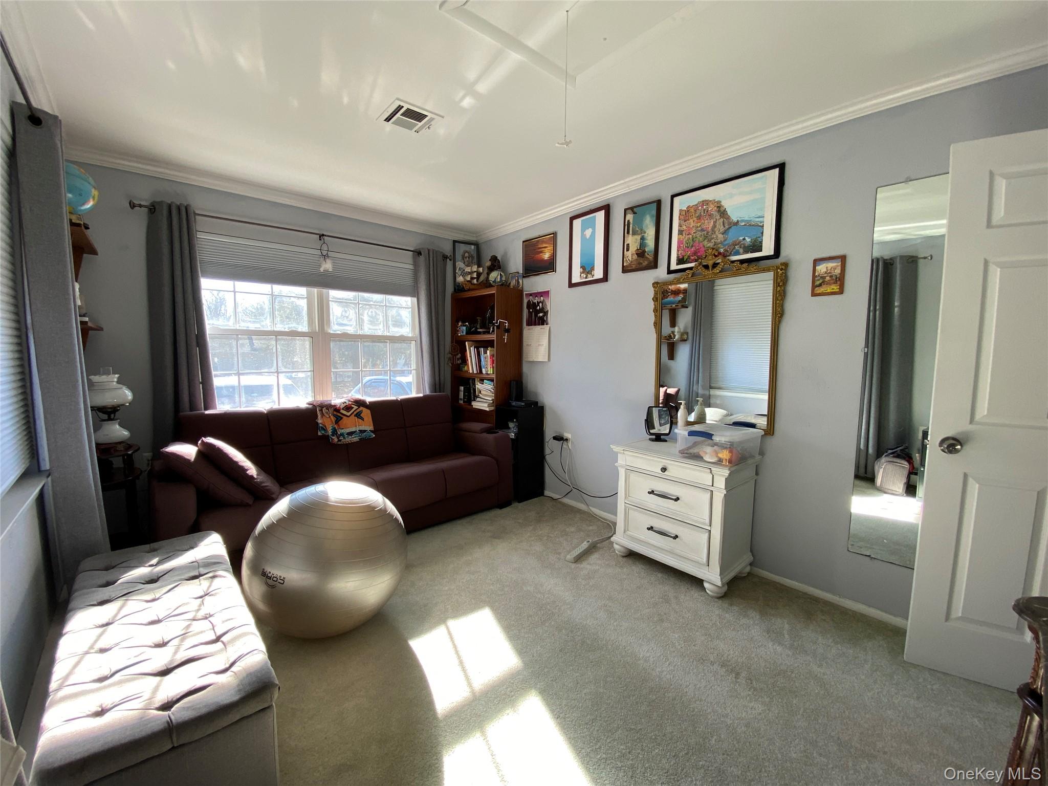 274 Berwick Court, Unit A Ridge, NY 11961 - Photo 21 of 31 Bedroom with light colored carpet, attic access, and ornamental molding