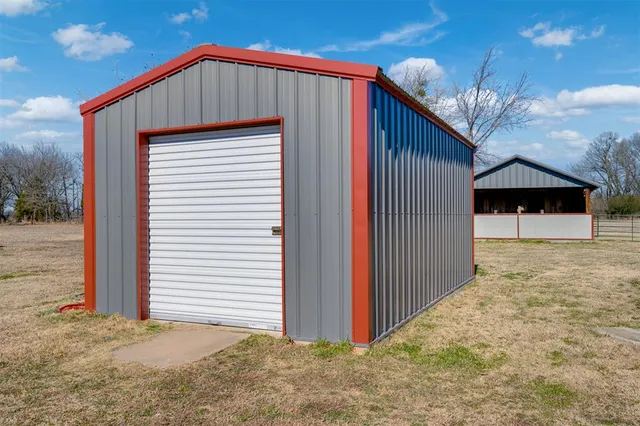 a view of a yard with wooden fence