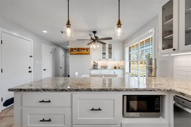 a kitchen with stainless steel appliances granite countertop a stove a sink and a granite counter tops