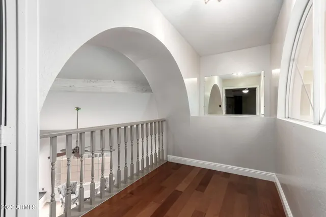 a view of an empty room with a fireplace and a window