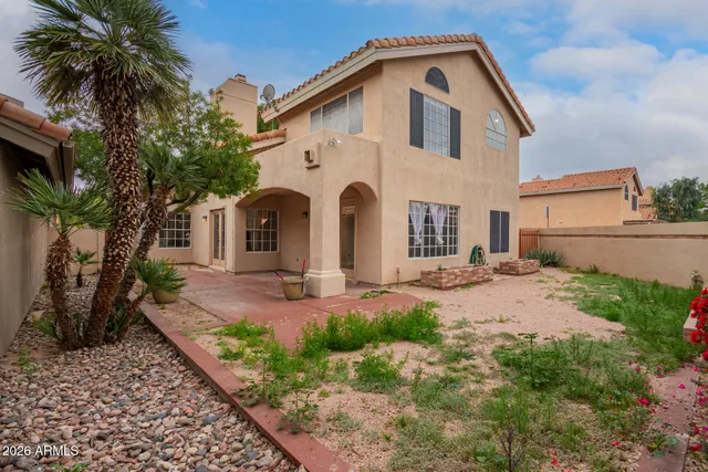 a view of a hallway with wooden floor and a bathroom