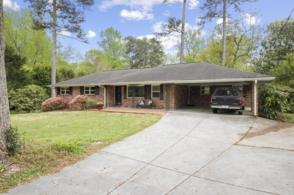 3883 Midvale Road Tucker, GA 30084 - Photo 1 of 1 a front view of a house with garden