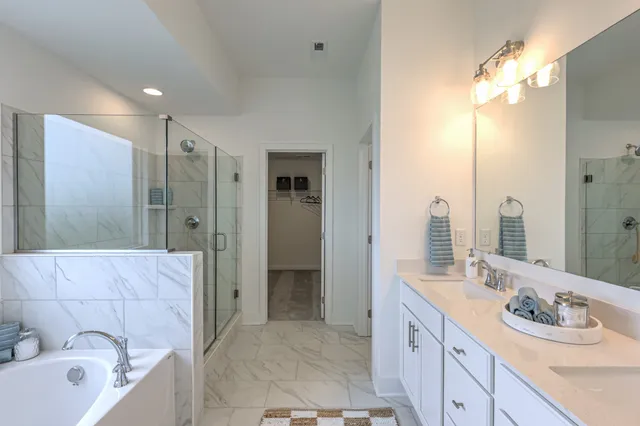 a kitchen with stainless steel appliances granite countertop a stove a refrigerator a kitchen island a table and chairs