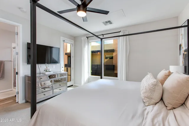 a bedroom with a bed and a view of living room