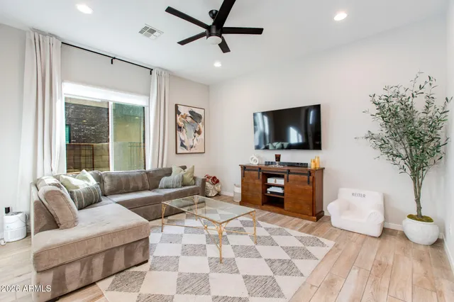 a living room with furniture and kitchen view