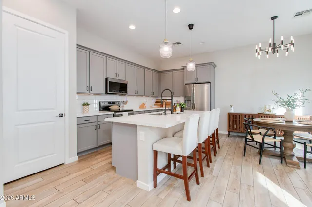 a kitchen with sink stove and refrigerator