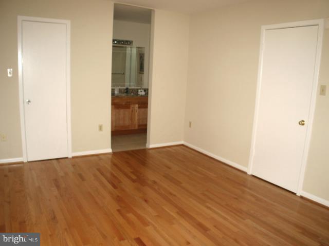 9247 Three Oaks Drive Silver Spring, MD 20901 - Photo 20 of 30 a view of empty room with wooden floor