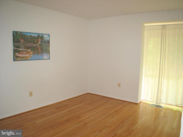9247 Three Oaks Drive Silver Spring, MD 20901 - Photo 23 of 30 an empty room with a wooden door