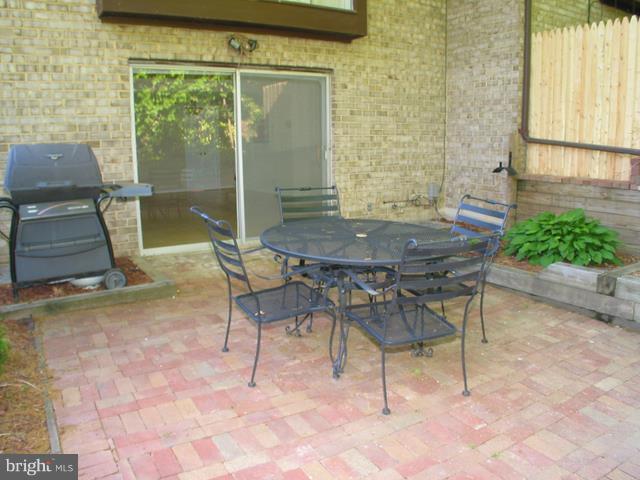 9247 Three Oaks Drive Silver Spring, MD 20901 - Photo 27 of 30 a patio with table and chairs