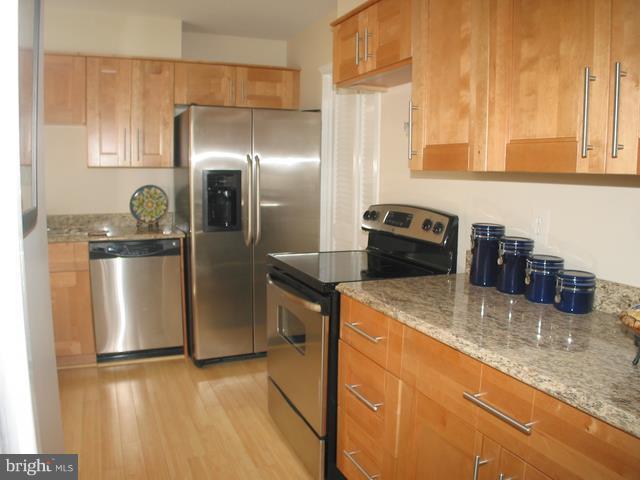 9247 Three Oaks Drive Silver Spring, MD 20901 - Photo 4 of 30 a kitchen with a refrigerator sink and stove