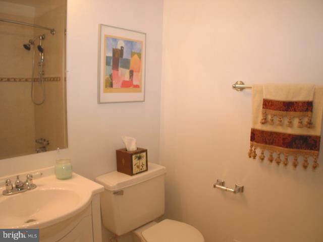 9247 Three Oaks Drive Silver Spring, MD 20901 - Photo 5 of 30 a bathroom with a toilet sink and mirror