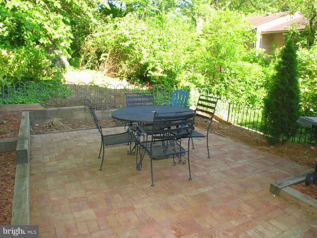 9247 Three Oaks Drive Silver Spring, MD 20901 - Photo 9 of 30 a view of a backyard with table and chairs and potted plants